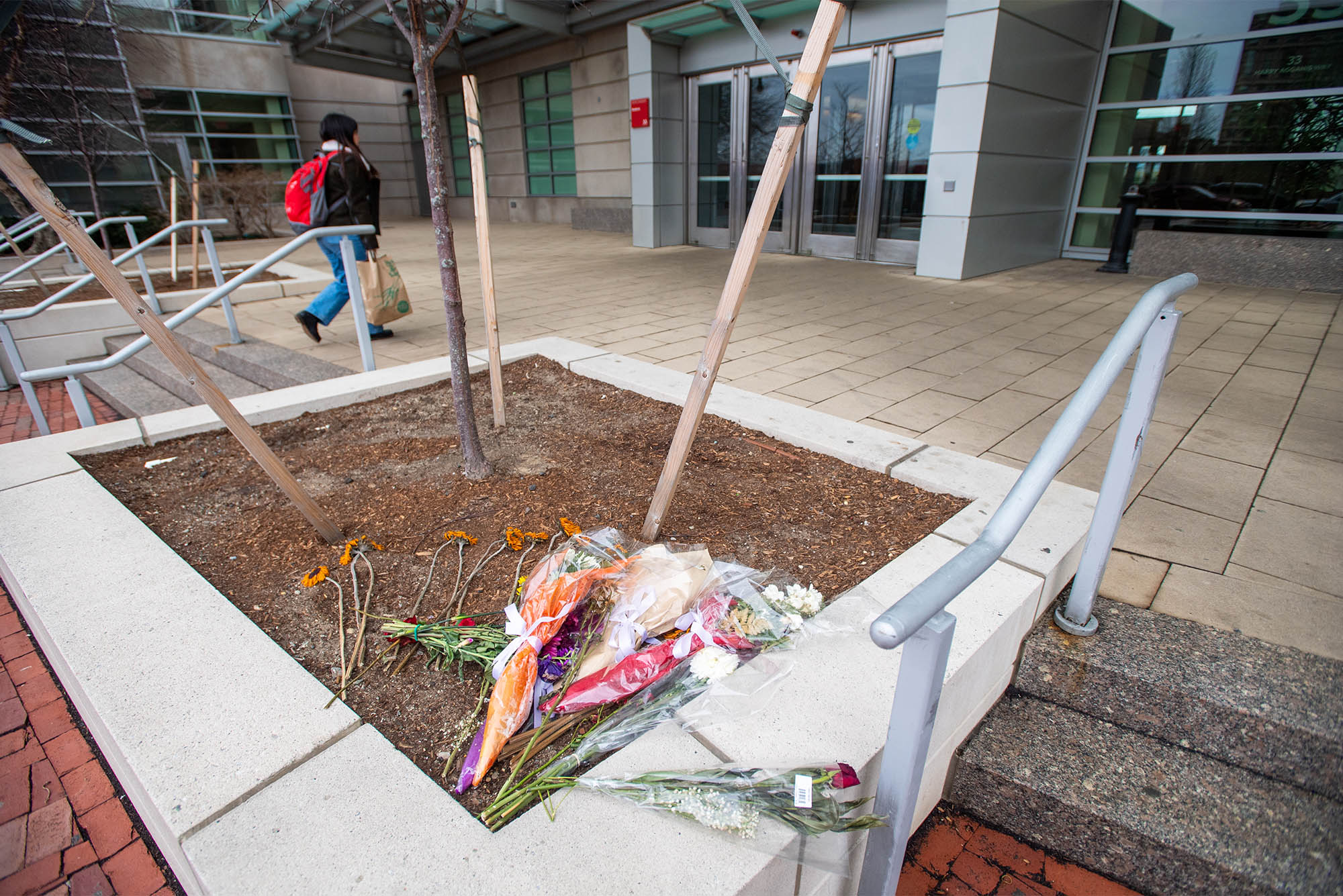 2/22/23 -- Boston, Massachusetts Flowers found laid out in front of StuviII. Last week, a 33-year of Cambridge resident died after jumping from the 26th floor of the building Photo by Cydney Scott for Boston University Photography