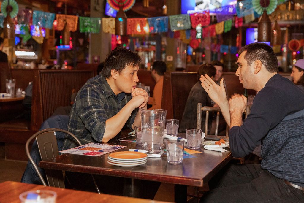 Jack Yeh (SPH’25) (left) and Halim Polat (ENG’27) chat over dinner.