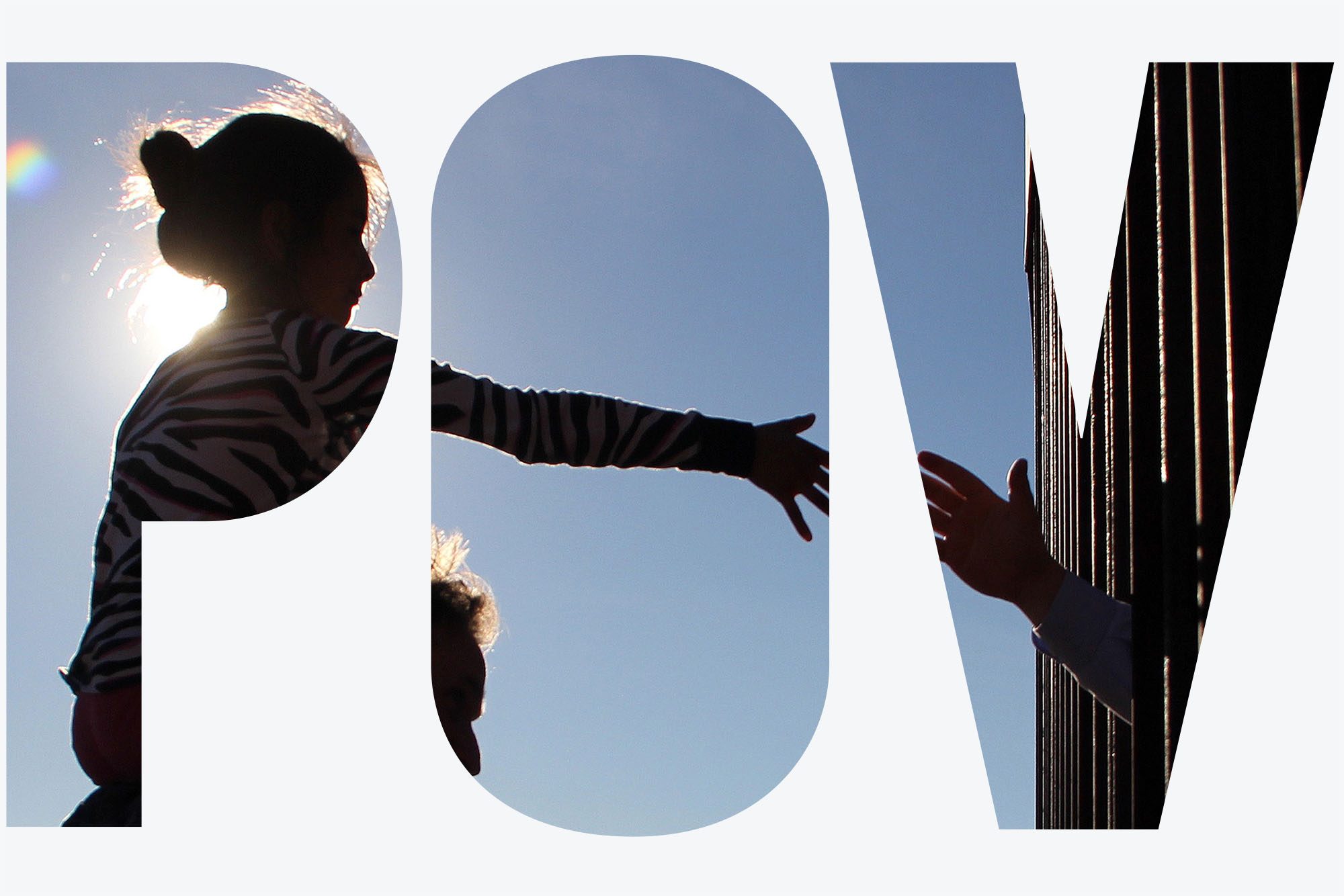 Photo: A girl from Anapra, a neighbourhood on the outskirts of Ciudad Juarez in Mexico, touches hands with a person on the United States through the border fence, during a prayer with priests and bishops from both countries to ask for the migrants and people of the area, on February 26, 2019. Silhouetted by the sun, a young girl sits on the shoulders of an adult as she reaches towards a shadow hand reaching through a fence. Photo is seen through a white overlay with transparent letters that read "POV".