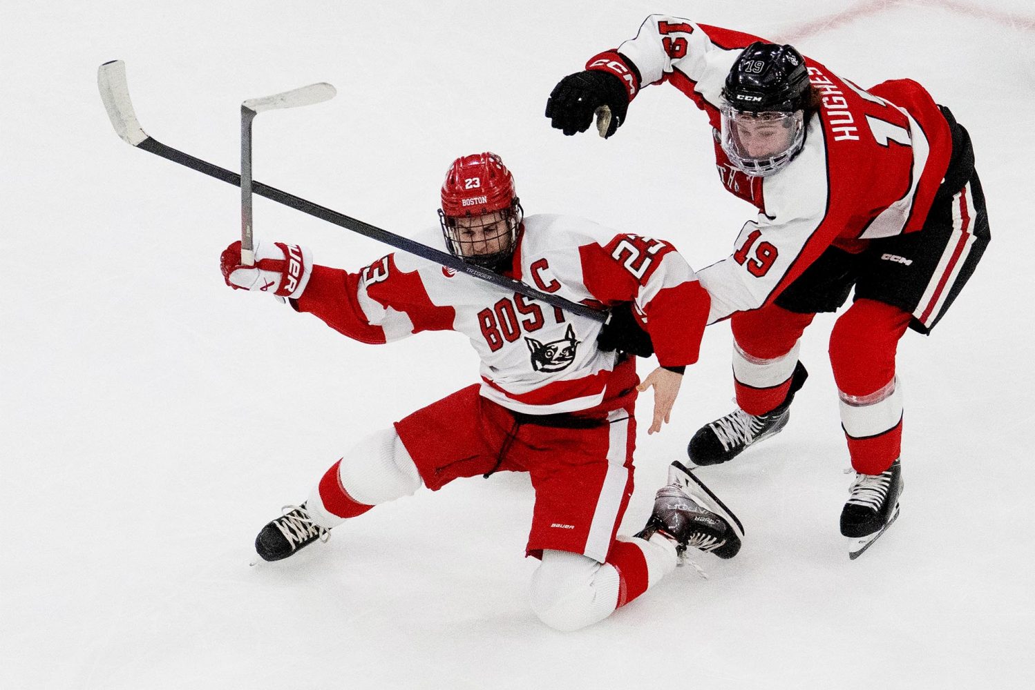 Terriers captain Domenick Fensore (CAS’23) is wrapped up by Northeastern defenseman Riley Hughes. The Huskies physicality played a large role in scoring their first two goals in Monday’s semifinal.
