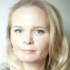 Photo: Headshot of Kaija Schilde, a blonde, white women with fair features. She stares into the camera.