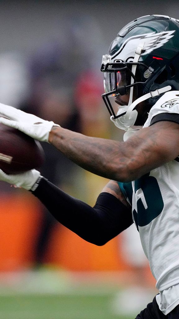 Photo: Philadelphia Eagles' C.J. Gardner-Johnson catches a pass during practice at the NFL football team's training facility, Friday, Feb. 3, 2023, in Philadelphia. A Black man wearing a dark green and white Eagles' football uniform and helmet catches a football in his hands.