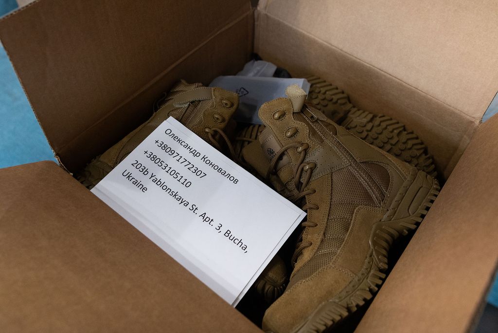 Photo: A box of combat, military boots. A piece of paper with numbers and information sits on top.