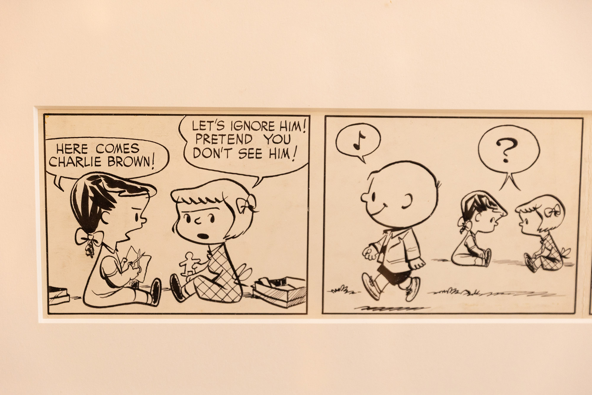 Photo: A framed photo of an original comic strip of the classic Peanuts comic.