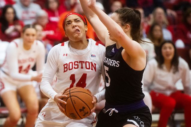 Guard Sydney Johnson (CAS’23) drives to the hoop in BU’s 65-61 loss to Holy Cross Sunday, March 12. Johnson was named a member of the Patriot League All-Tournament Team.