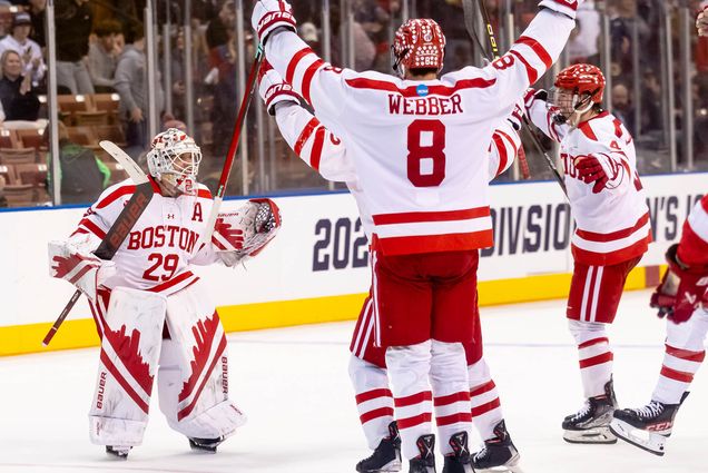 Photo: Weber, #8 on the BU Men's Hockey Team, raises his arms in celebration as he skates towards the goalie, also celebrating