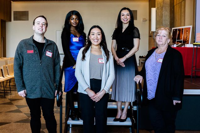 Photo: Group photo of the BU 2023 Best Student and Supervisor Award winners. (Left to right) Daniel Kirsch (Graduate Student Outstanding Service ) , Kenya St. Fleur (Undergraduate Student of the Year) Christie Ngo (Grad student Employee of the Year , Dr. Monica Wang (Supervisor of the Year-Runner-Up) and Mary Martins (Supervisor of the Year ) (not pictured Christina Matta, Undergraduate Student Employee of the Year) stands next to a stage in a bright room. They all pose together and smile for the photo.