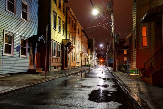 Photo: A neighborhood in South Boston at night with 3 story row houses of various colors