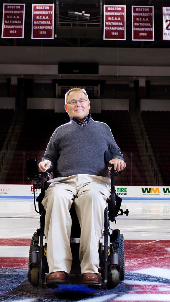 Photo: Travis Roy, a man in a wheelchair, poses for a photo in the center of a hockey rink on Monday, October 6, 2015 at Agganis Arena Photo By Jackie Ricciardi for Boston University Photography