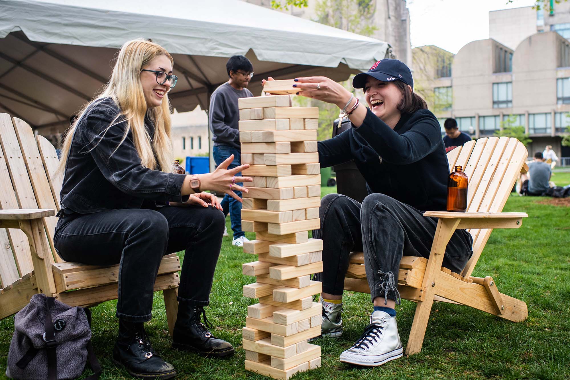 Photo: Eden McColl (SHA 21) and Morgan Michelson (SHA 21) play a game of Jenga during Senior Week on May 10, 2021.   Photo by Jackie Ricciardi for Boston University