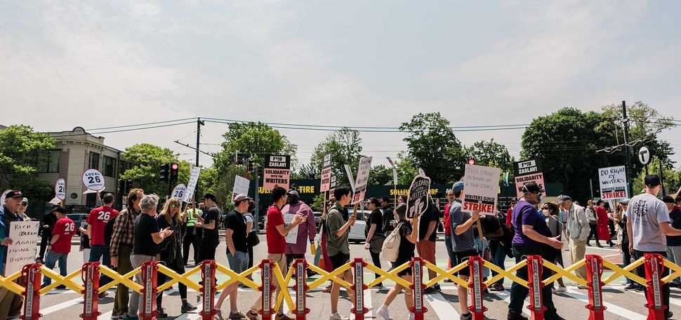 Photo: Protestors outside Harry Agganis Way support the Writers Strike admist the annoucement of David Zaslav as Commencement Speaker for BU's 150th Commencement.