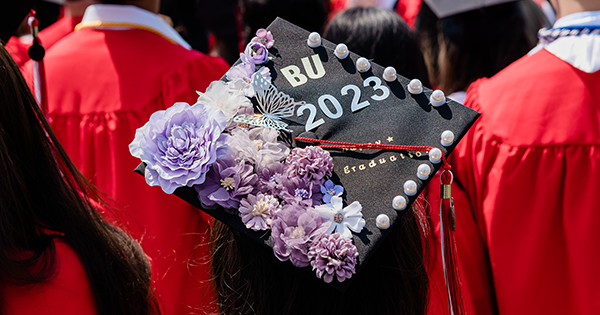 Photo: A decorated cap with purple flowers on the left side and bold letters that read "BU 2023".