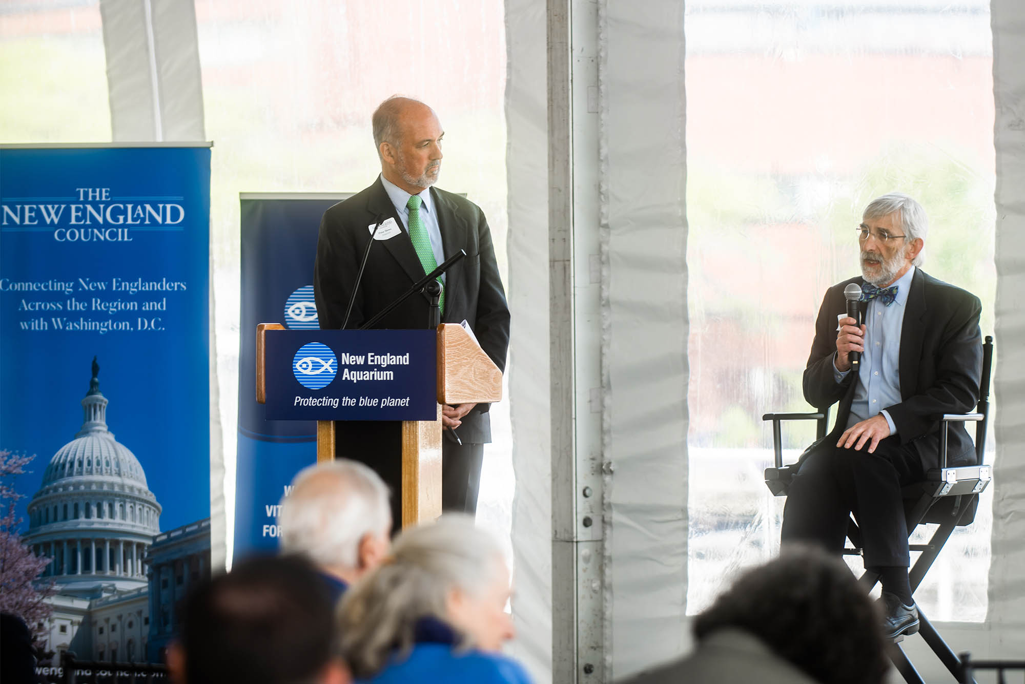 Photo: Dennis Carlberg, associate vice president for BU Sustainability (a white man wearing a suit on the right), speaks on a panel about climate change in the region at the New England Aquarium on May 23. Helping moderate the event was Peter J. Howe (left), senior vice president of Boston public relations firm Denterlein.