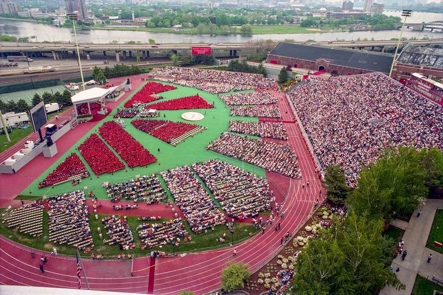 Photo: Bird's eye view of Nickerson Field during Commencement showing thousands of spectators and graduates on May 16, 1993.