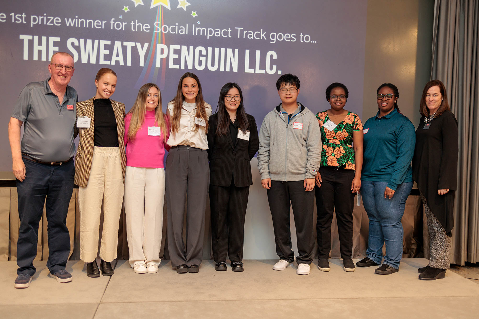 Photo: A group of people stand and pose for a photo in front of a sign that reads "2023 New Venture Competition Winners". Ian Mashiter, director of curriculum at Innovate@BU (from left), Hallie Cordingley (CAS’24), Mikayla Crowley (ENG’23), Katie Hill (ENG’23), Qi Xia (COM’23), Yunan Liao, Stephanie Anakwe (CAS’22), Lois Anakwe, and Siobhan Dullea, executive director of Innovate@BU.