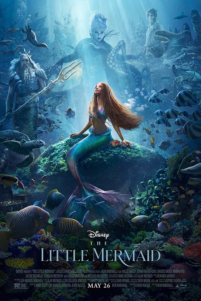 Photo: Movie poster for The Little Mermaid. Ariel with red long braids is looking up with a composite of Ursala behind her in the sea. Her father is to the left and Prince Eric is to the right.