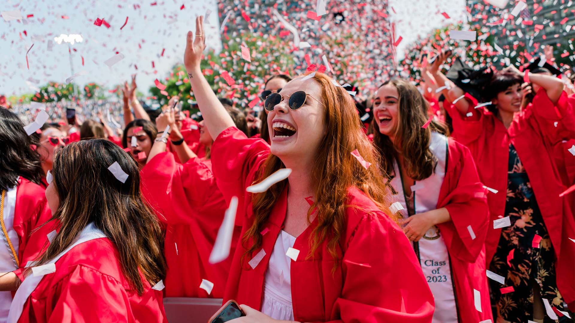 Photo: A large sea of graduates in red robes with black caps celebrate at the 150th Boston University Commencement