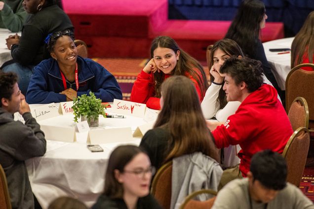 Photo: Two young women, Francesca Crescentini (CGS’25), left, and Sasha Balderrman (CGS’25), center facing, chat with other first years during an exercise covering core values during freshman orientation June 8 at the GSU. Photo by Cydney Scott for Boston University Photography