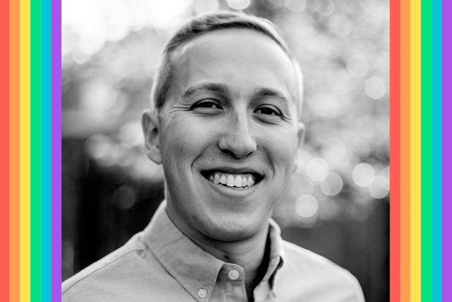 Black and white headshot of Ethan Sobel (COM’13) smiling in a light colored button down shirt with the background blurred.