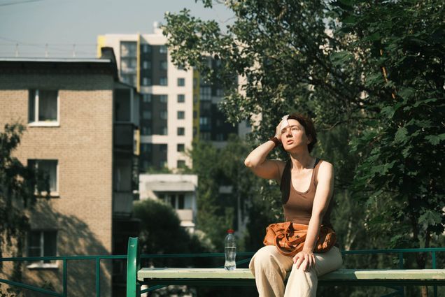 Photo: Mature woman is feeling bad during the heat wave in city