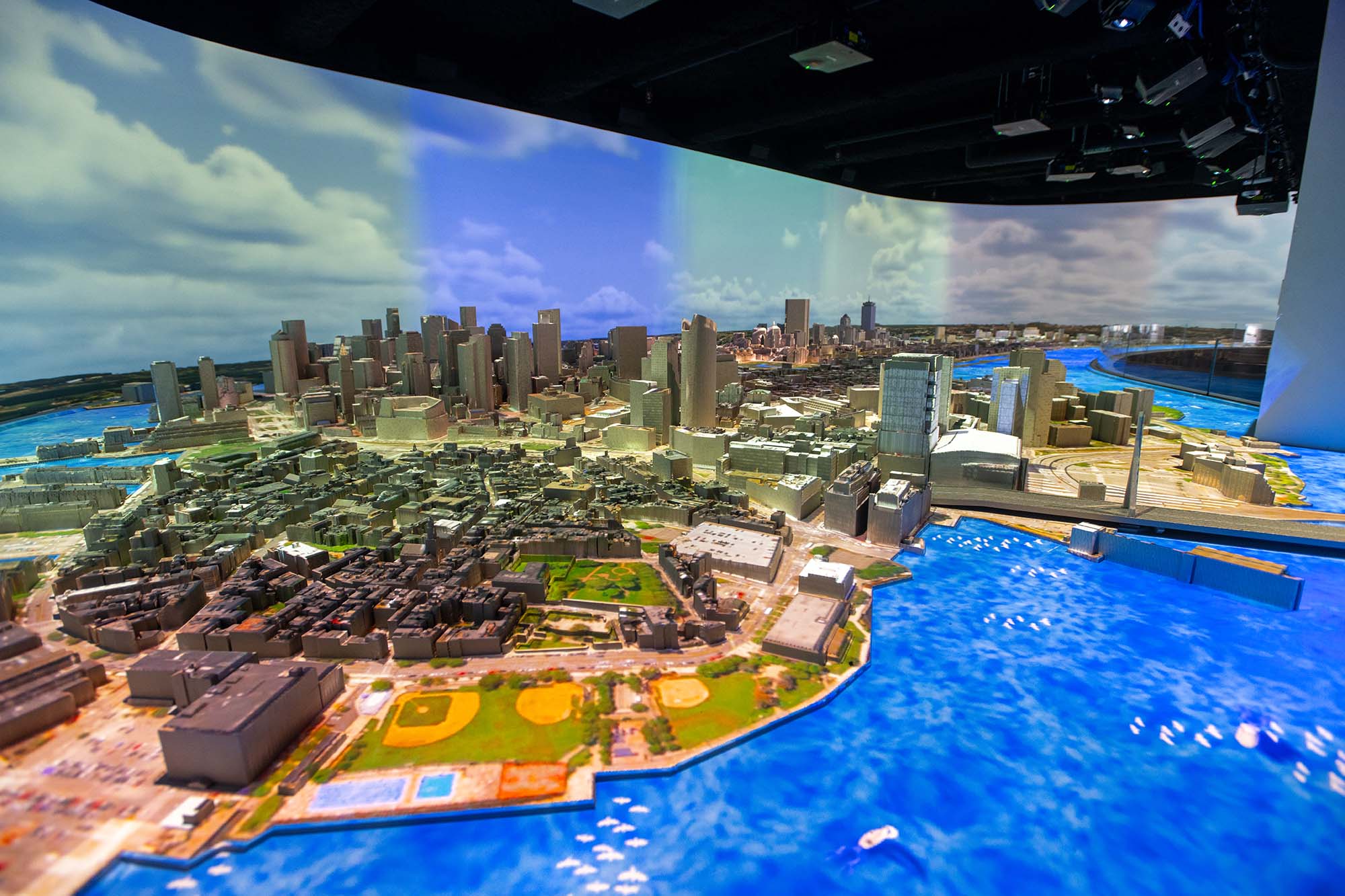 Photo: A small, realistic model of the entire city of Boston is shown. Projectors project a light show called Boston 365, onto the model.