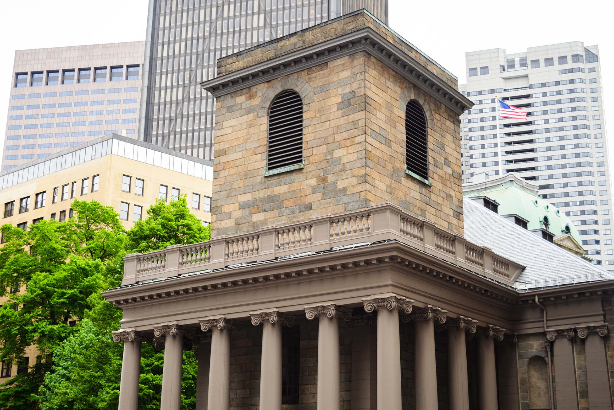 Photo: A large stone building with a rounded window atop a tower in downtown Boston.