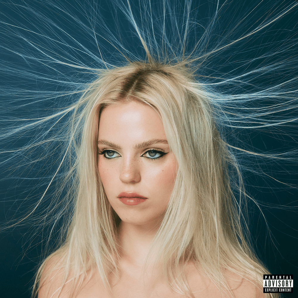 Photo: A bleach-blonde woman stares off to the left dramatically while her hair stands up in all directions from static electricity.