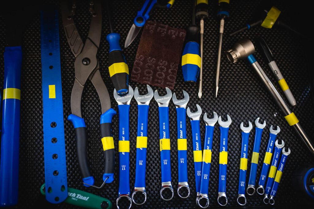 Photo: A variety of bike tools are shown arranged on a black mat.