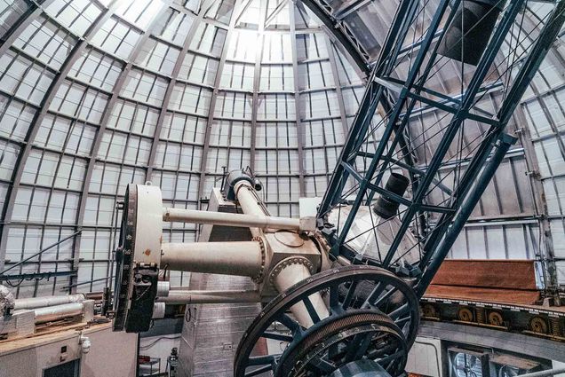 Photo: Interior of the Perkins Telescope Observatory in Flagstaff, Arizona. An enormous telescope is shown inside a large, steel framed-dome.