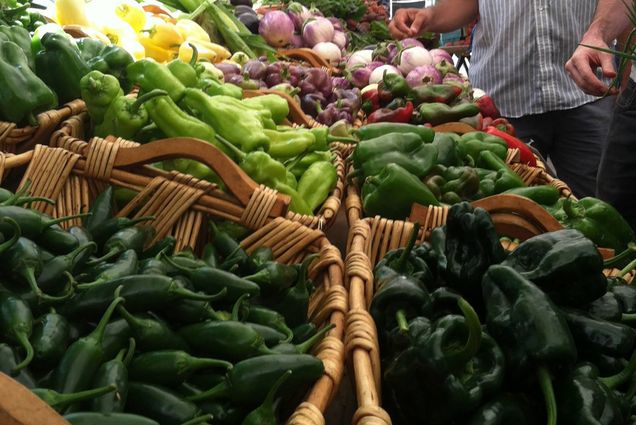 Photo: Various baskets of multiple peppers. Some are green, others are red, some are stout, others are longer.