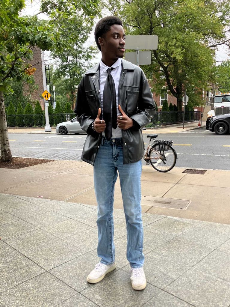 An Asian Man In A Black Denim Jacket And A Chain Necklace Posing