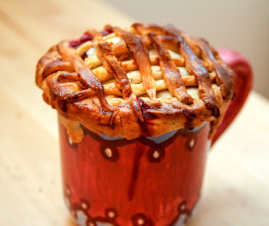 This is apple pie but made in a red mug. The top is criss-crossed and browned from being cooked.