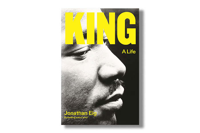 Image: Book cover for Jonathan Eig's book "King: A Life". Cover shows zoomed in Black and white photo of Martin Luther King Jr. looking pensive. In large neon yellow font the word "King" is shown at the top. In smaller letters below that it reads "A life". Author's name shows in same small font size in the bottom elft.