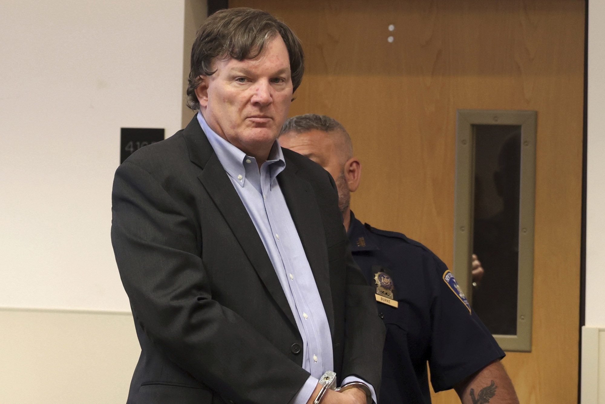 Photo:Rex A. Heuermann, the architect accused of murdering at least three women near Long Island’s Gilgo Beach, appears before Judge Timothy P. Mazzei in Suffolk County Court. He is a white man wearing a regular suit.