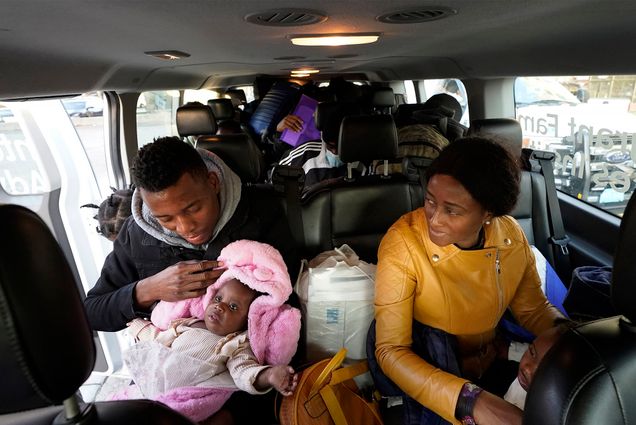 Photo: A family of immigrants in a car full of luggage in Boston, MA, heading for a shelter in Quincy MA