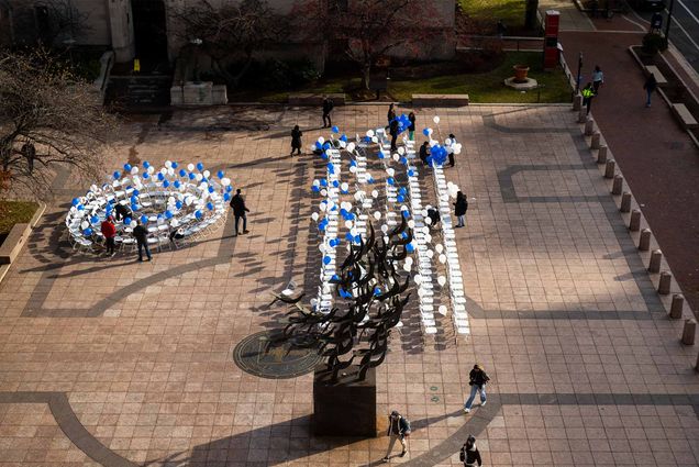Photo: 137 chairs placed in a large open plaza, each with a photo of a hostage attached, set up in rows represent those still being held hostage, or those whose bodies are still in Gaza. A circle of chairs, many with more than one victim depicted on a chair, represent the 113 hostages who have been released.