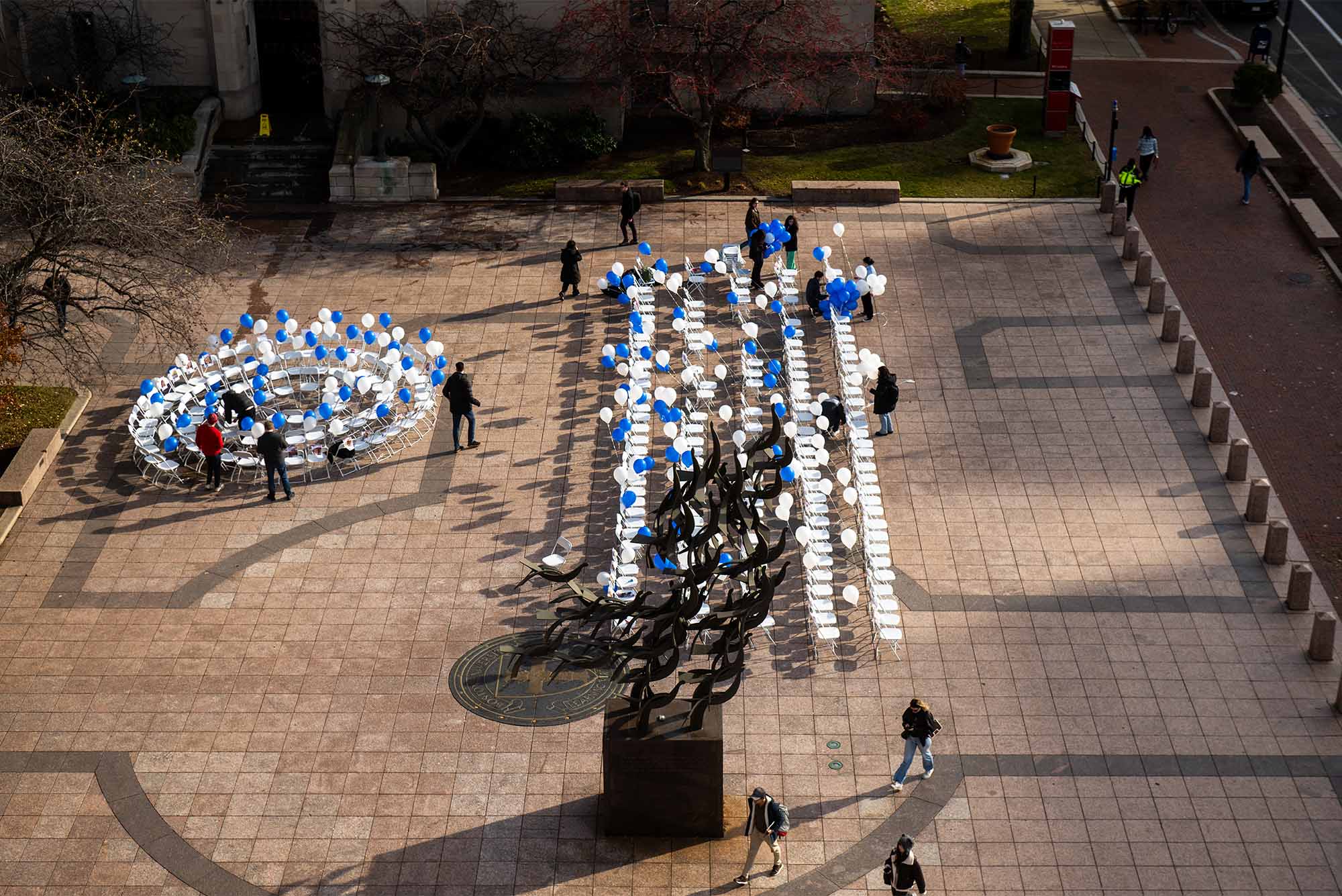 Photo: 137 chairs placed in a large open plaza, each with a photo of a hostage attached, set up in rows represent those still being held hostage, or those whose bodies are still in Gaza. A circle of chairs, many with more than one victim depicted on a chair, represent the 113 hostages who have been released.