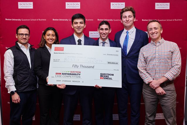 Photo: Questrom Sustainability Competition winners, Mikhail Gurevich (ENG’07, Questrom’12) (from left), who donated the $50,000 prize; winners Illiana Arroyo (CAS’25), Suraj Nellore (Questrom’26, COM’26), Jason Wexler (Questrom’25, COM’25), and Devin Hirsch (Questrom’25), stand holding a big cheque for their idea, ReBean.