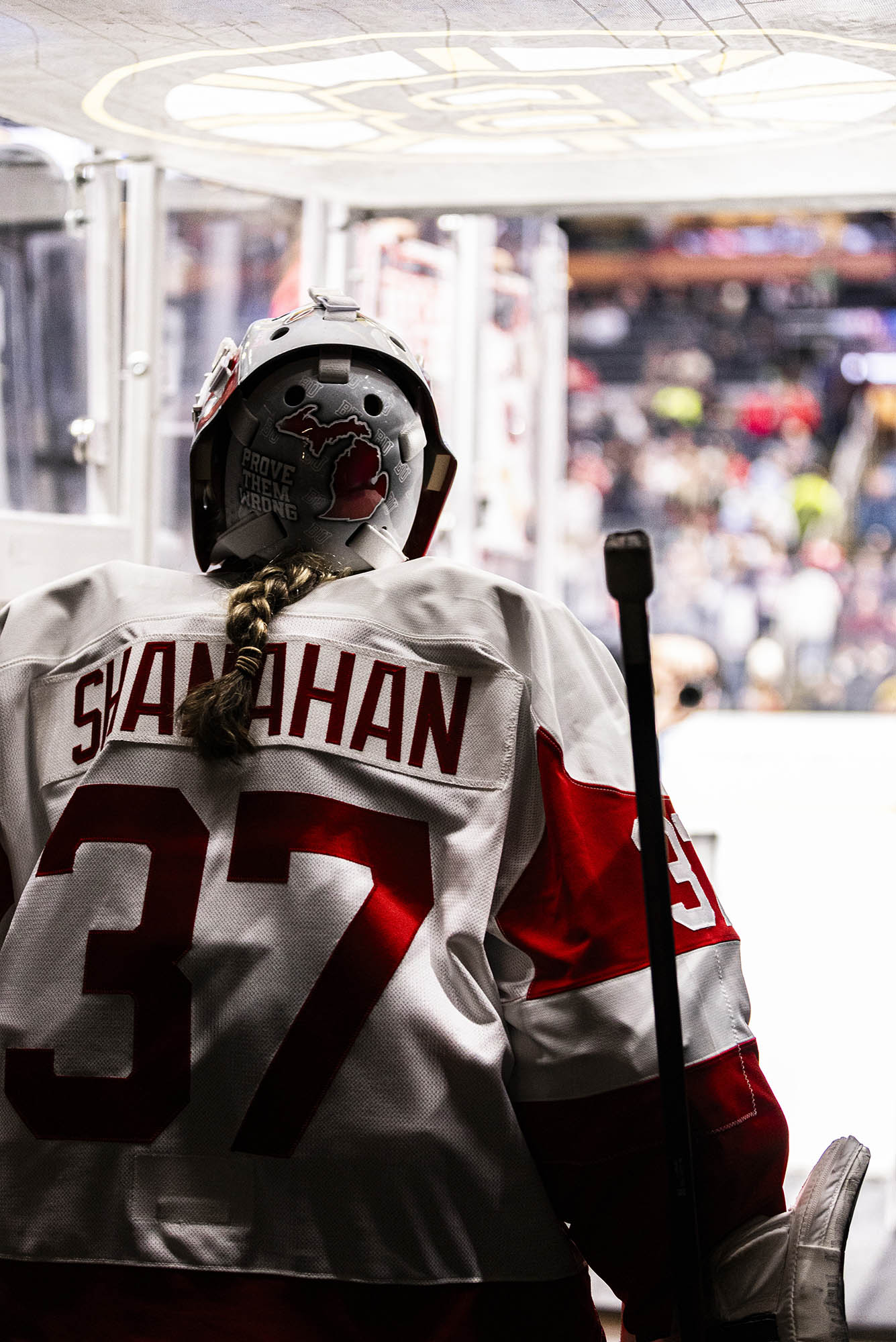Photo: Callie Shanahan, BU's goalie, goes to step onto the ice geared up in her white uniform.