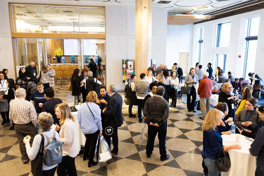 Photo: A crowd of audience members for the Civic Center Summit linger in the lobby.