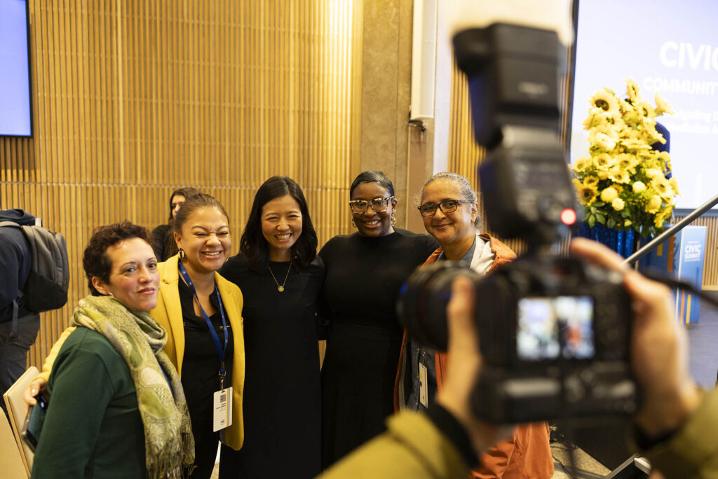 Photo: Michelle Wu, mayor of Boston poses with four other woman for a photo at he Civic Center Summit.