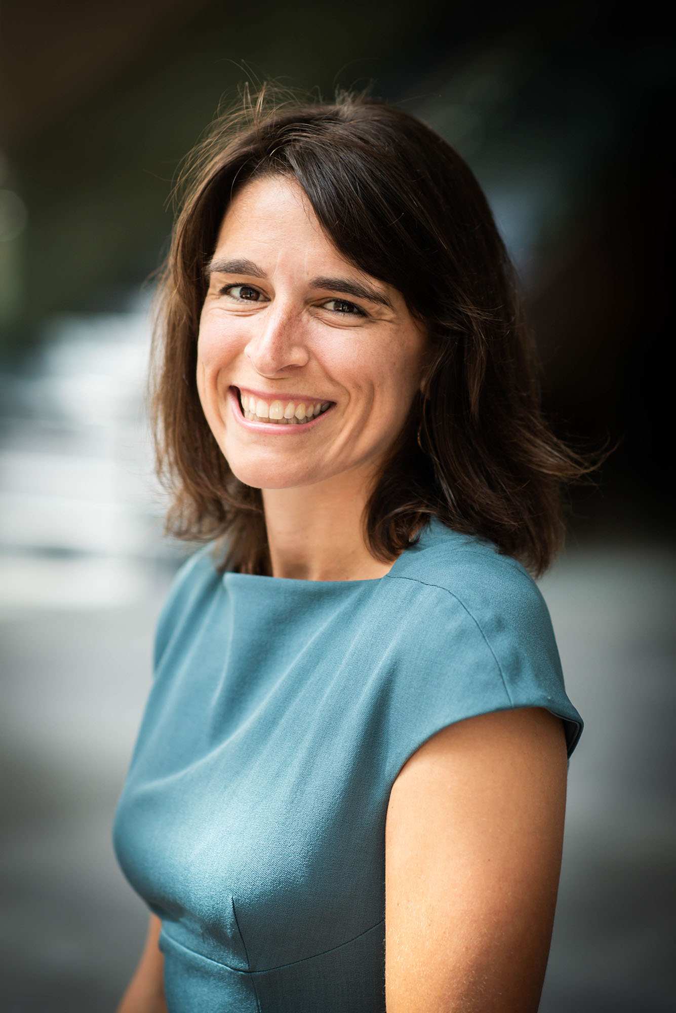 Photo: A portrait image of Sarah Sherman, a white woman with short brown hair. She wears a blue shirt.