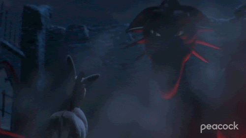 Gif from the Shrek movie. The purple dragon, Elizabeth, puts her head down to smile and make eye contact with the animated donkey.  