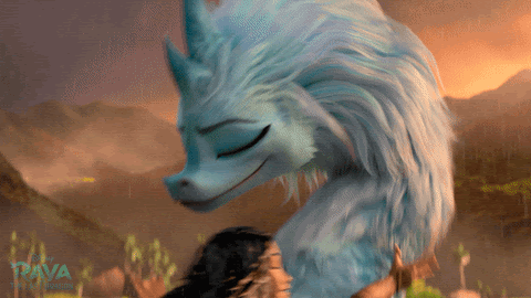 A GIF from the movie “Raya and the Last Dragon." The animated dragon is smiling and hugging a human. 