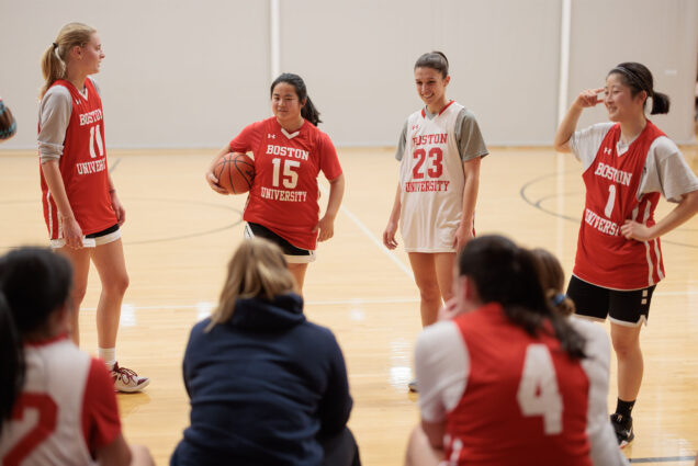 Photo: Members of the BU Women's club basket ball team in various jerseys that are red and white at a recent practice
