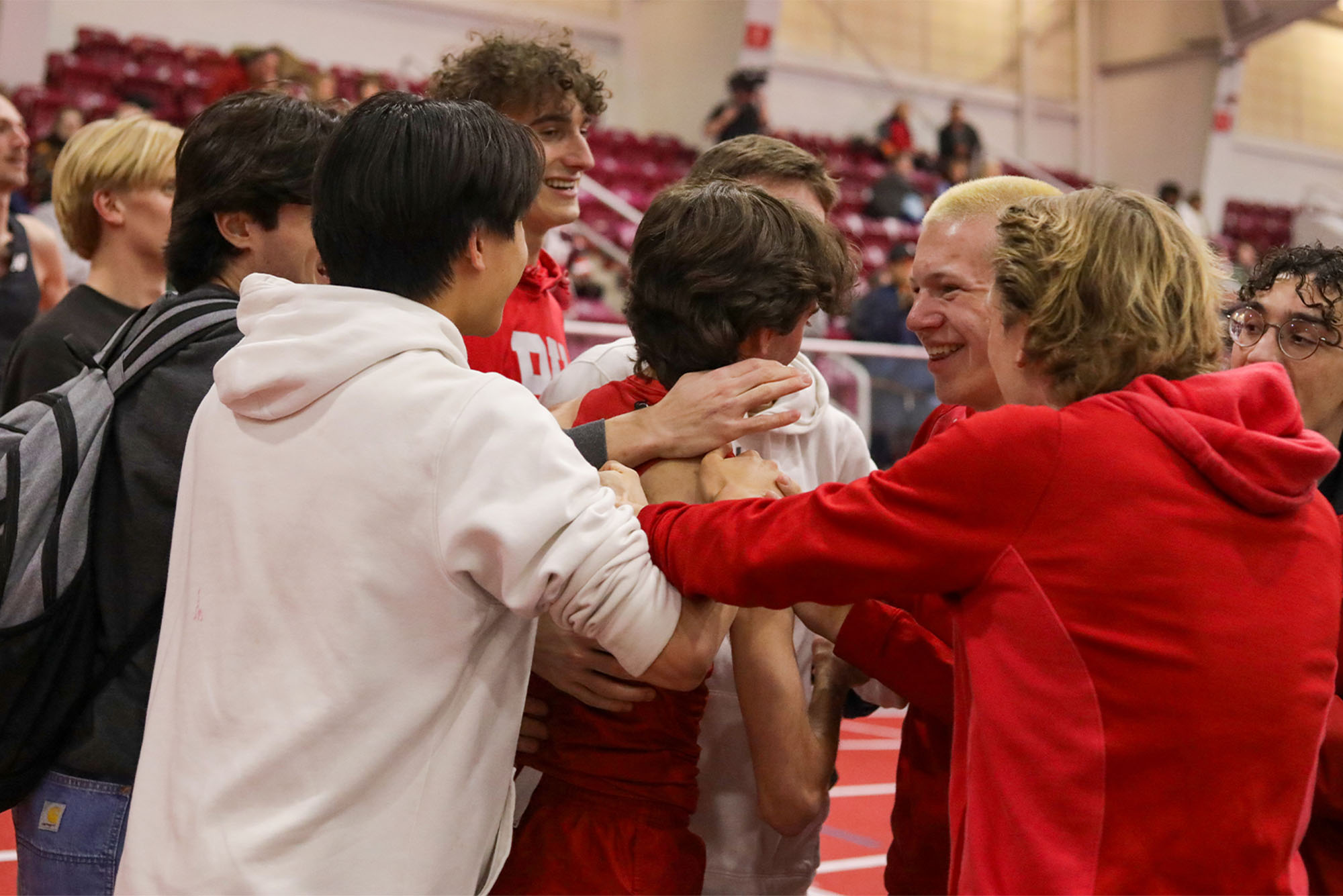 Photo: A group of college athletes celebrating together at a recent track and field meet