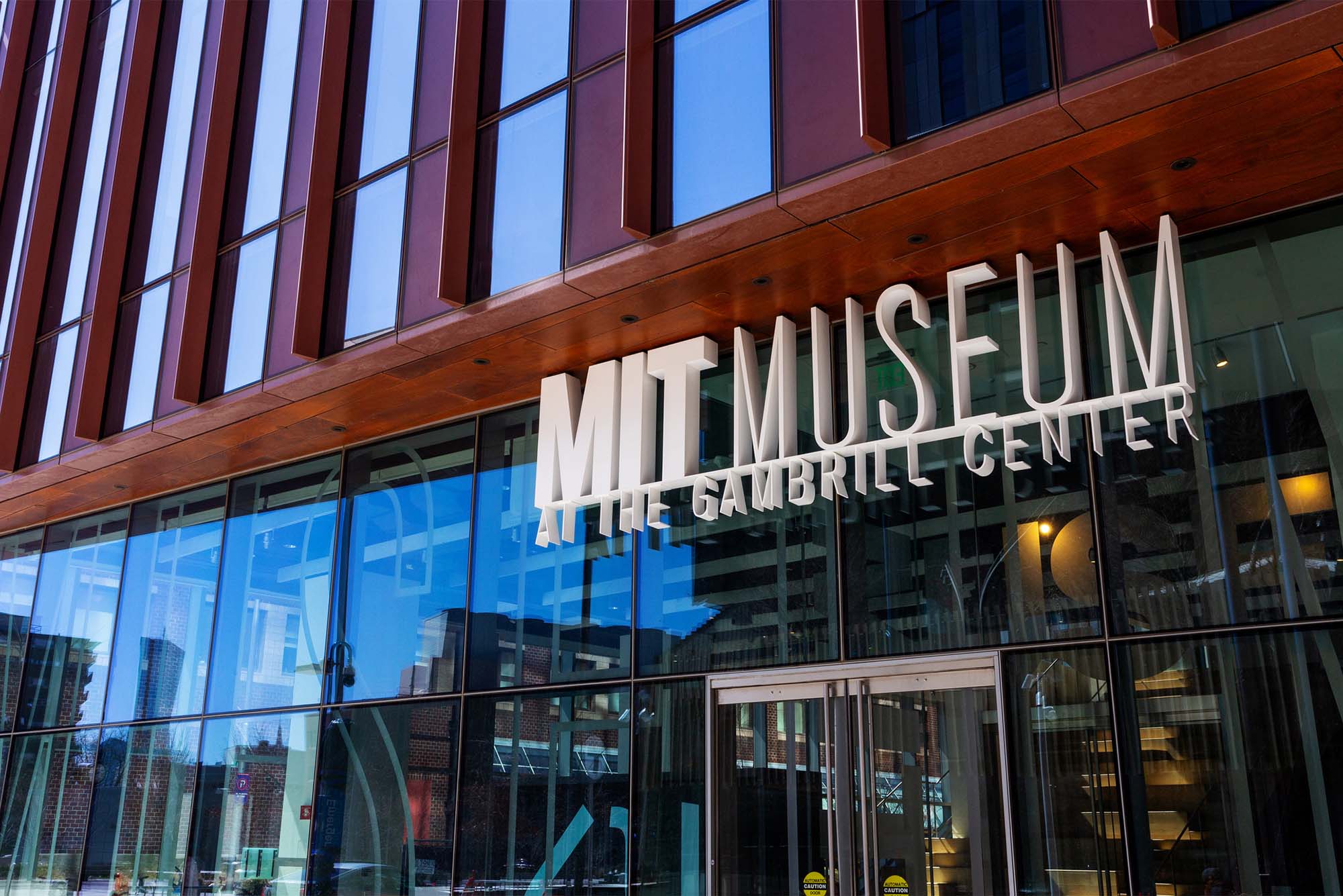 Photo: Front of a large modern building with a sign reading "MIT Museum at the Gambrill Center"