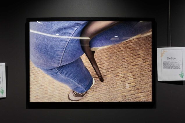 Photo: A shot of a photo. The photo is a picture of a leg in a chair that is too small for them, showing how uncomfortable the fit is.