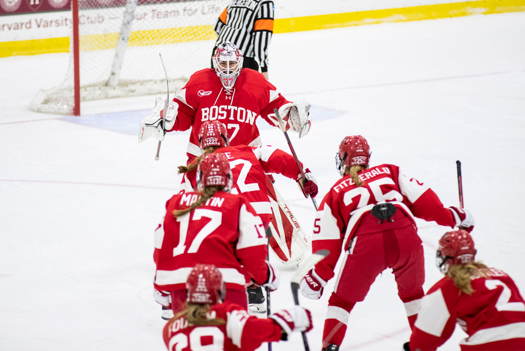 Photo: A group of women's hockey players in red and white jerseys celebrate after the shootout during the beanpot semifinals