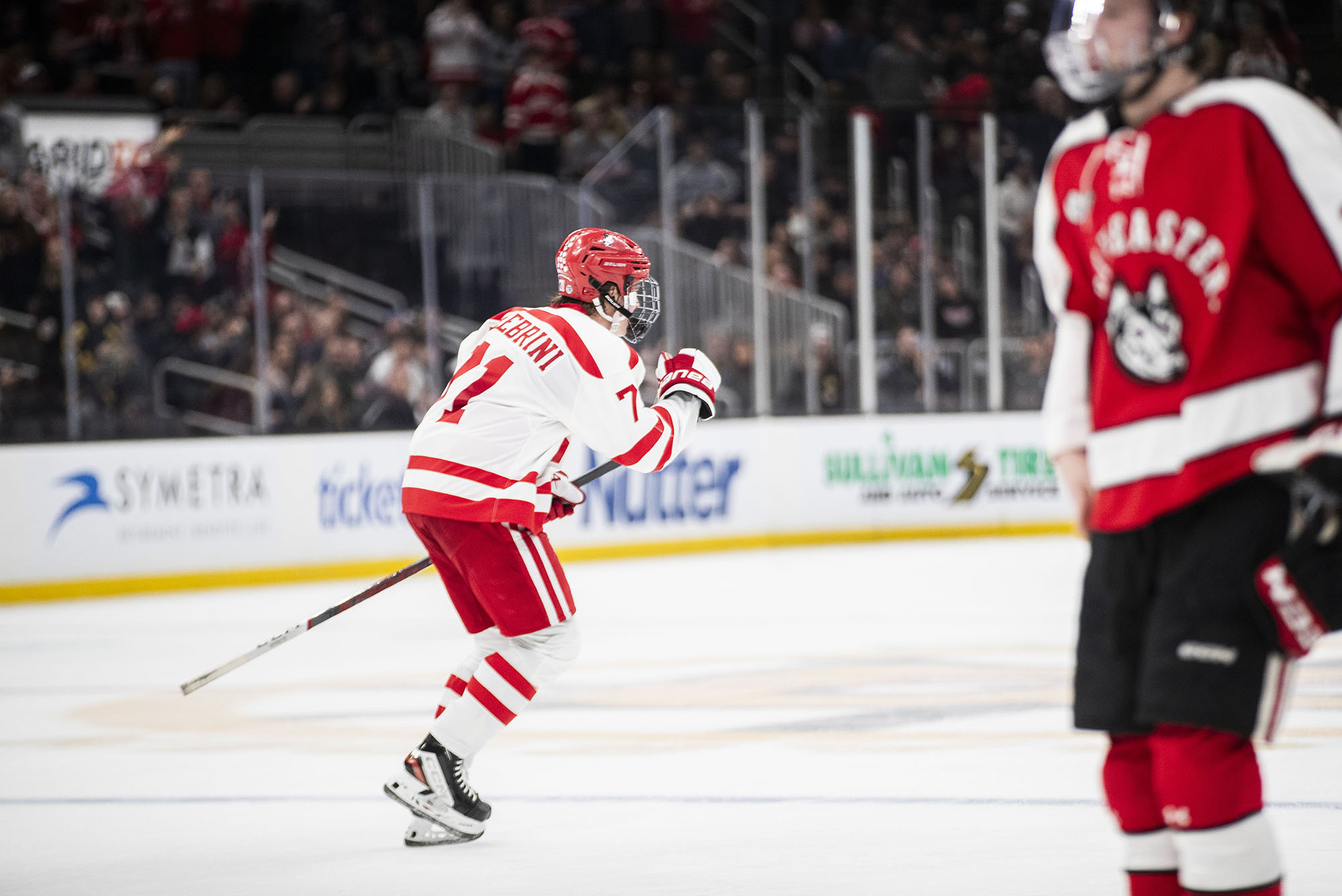 Photo: Player Celebrini, #71, celebrates after he scores the first goal in the game. He is wearing his all white jersey with red detailing.